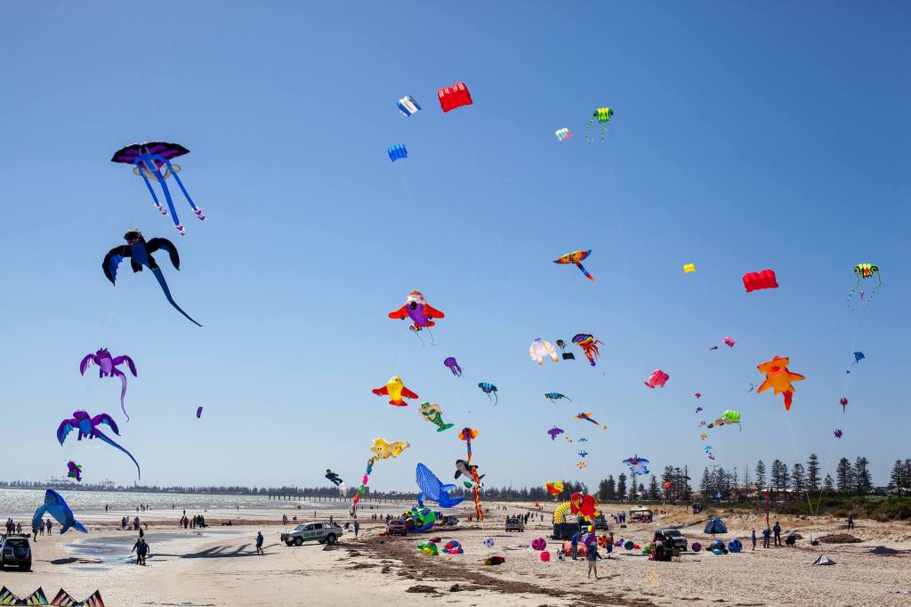 Wide show of many colourful kites at Adelaide International Kite Festival, Semaphore.